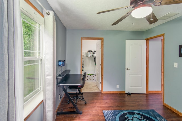 office featuring baseboards, a textured ceiling, and wood finished floors