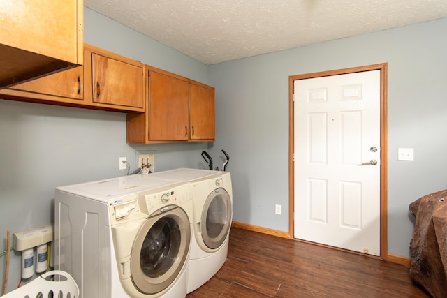 clothes washing area with baseboards, dark wood-style floors, cabinet space, a textured ceiling, and independent washer and dryer