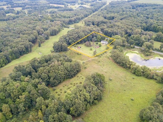 drone / aerial view with a view of trees and a rural view