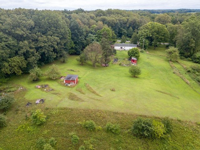 aerial view featuring a rural view and a wooded view