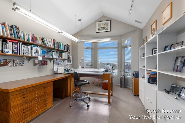 home office featuring built in desk, lofted ceiling, and visible vents