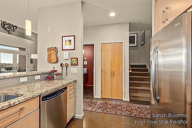 kitchen with light stone countertops, appliances with stainless steel finishes, baseboards, decorative backsplash, and recessed lighting