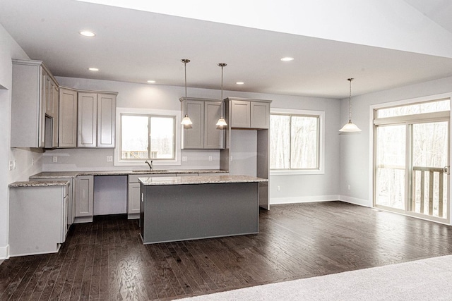 kitchen featuring a kitchen island, recessed lighting, a sink, gray cabinetry, and dark wood-type flooring