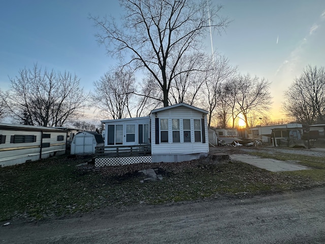 view of front of property featuring a storage shed and an outdoor structure