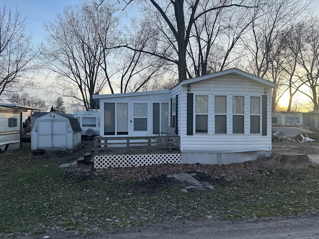 manufactured / mobile home featuring a storage shed and an outdoor structure