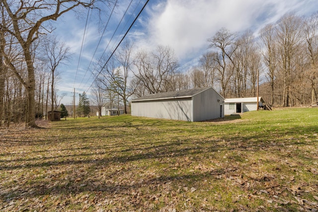 view of grassy yard with an outbuilding and an outdoor structure
