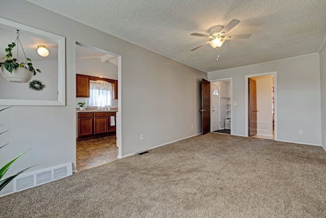 unfurnished living room with carpet floors, visible vents, and a ceiling fan