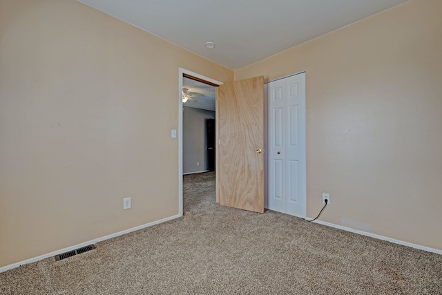 interior space with baseboards, visible vents, and carpet