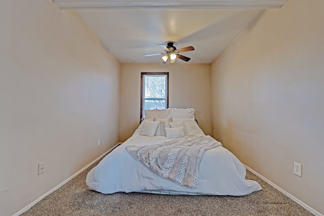 carpeted bedroom featuring baseboards and a ceiling fan