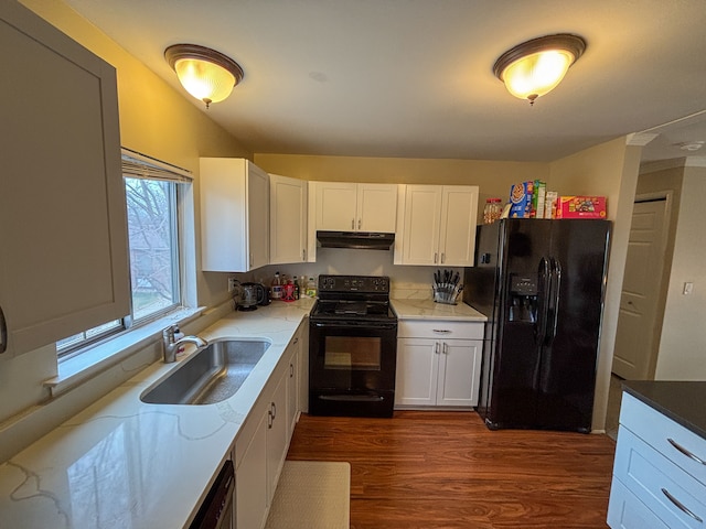 kitchen featuring a sink, under cabinet range hood, black appliances, and white cabinets