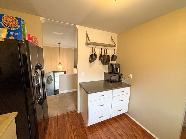 kitchen with baseboards, dark wood finished floors, black fridge with ice dispenser, dark countertops, and white cabinets