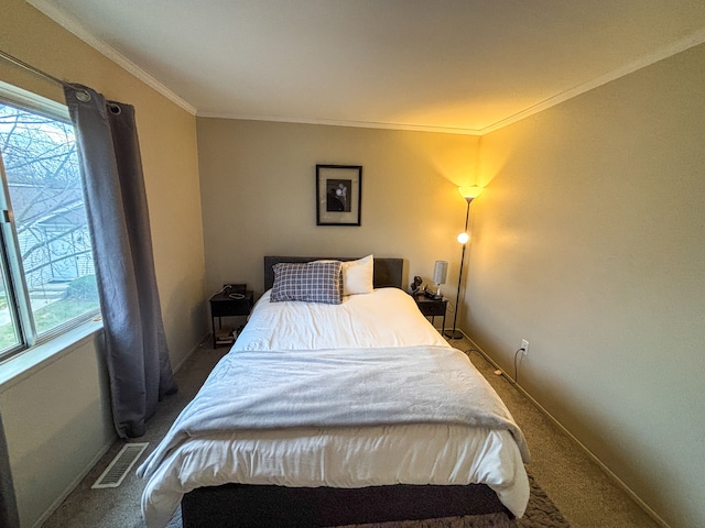 bedroom with ornamental molding, carpet flooring, visible vents, and multiple windows