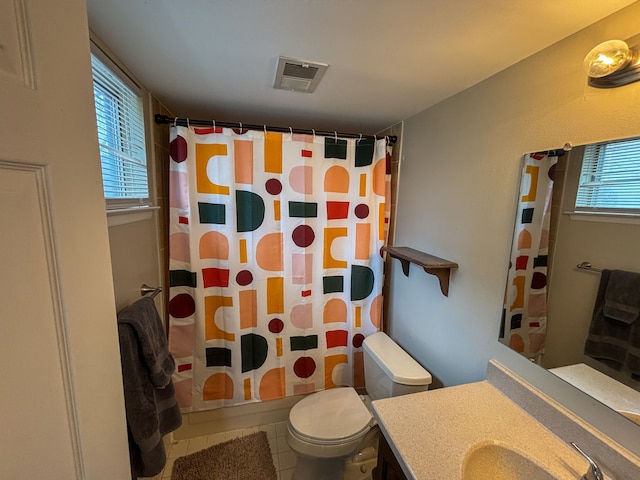 bathroom featuring toilet, shower / bath combo, visible vents, tile patterned flooring, and vanity
