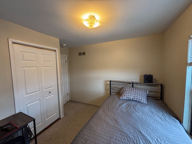 carpeted bedroom with a closet and visible vents