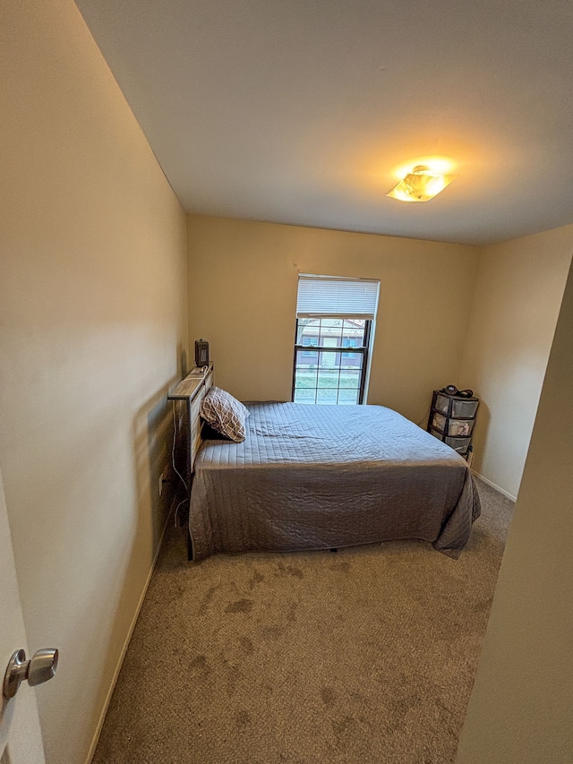 carpeted bedroom with baseboards