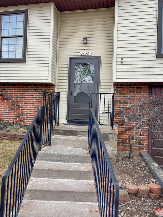 entrance to property with brick siding