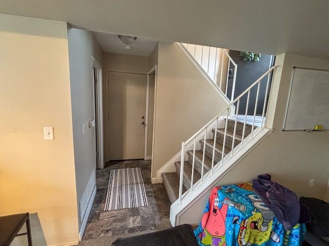 staircase featuring baseboards