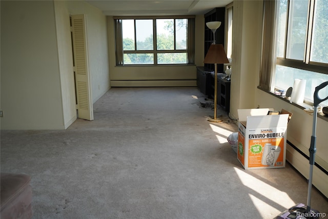 8900 E Jefferson Ave Unit 420 421, Detroit, MI 48214 - living room with a baseboard heating unit and light carpet