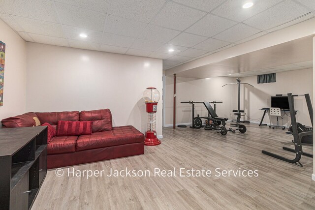 workout room with baseboards, recessed lighting, and wood finished floors