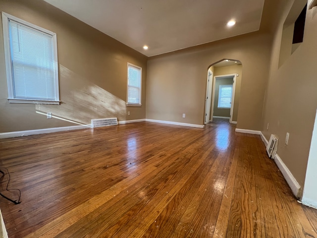 10026 Coyle St, Detroit, MI 48227 - interior space with arched walkways, baseboards, visible vents, and wood-type flooring