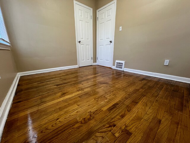 10026 Coyle St, Detroit, MI 48227 - empty room featuring baseboards, dark wood-style floors, and visible vents