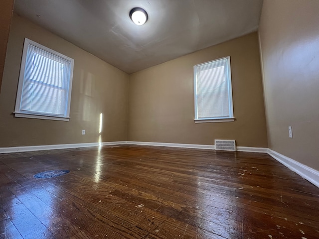 10026 Coyle St, Detroit, MI 48227 - unfurnished room with hardwood / wood-style flooring, baseboards, vaulted ceiling, and visible vents