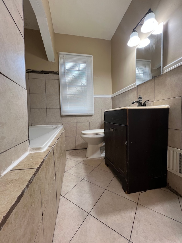 10026 Coyle St, Detroit, MI 48227 - full bathroom with vanity, tile walls, tiled bath, toilet, and tile patterned floors