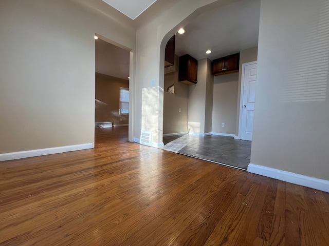 10026 Coyle St, Detroit, MI 48227 - spare room with arched walkways, visible vents, baseboards, and wood-type flooring