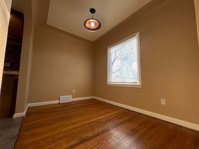 10026 Coyle St, Detroit, MI 48227 - empty room featuring baseboards, visible vents, and dark wood-type flooring
