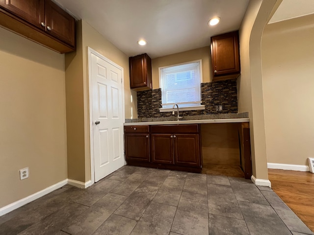 10026 Coyle St, Detroit, MI 48227 - kitchen with a sink, baseboards, decorative backsplash, recessed lighting, and dark brown cabinets