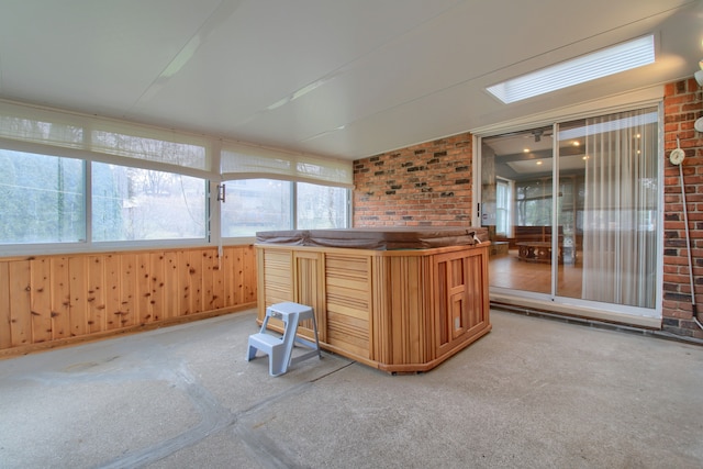 unfurnished sunroom featuring a hot tub