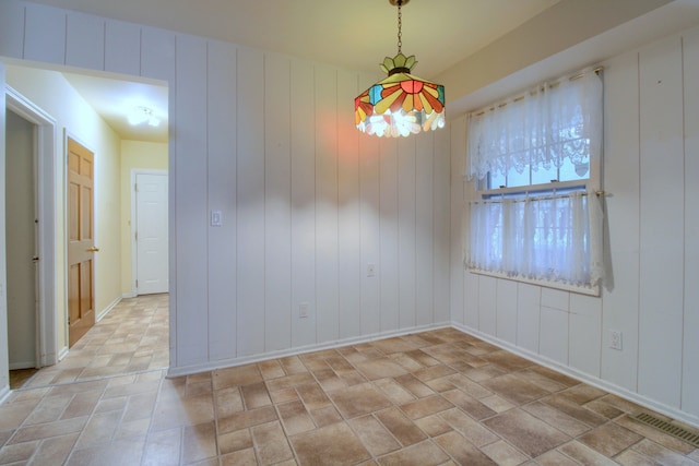 spare room featuring baseboards and visible vents