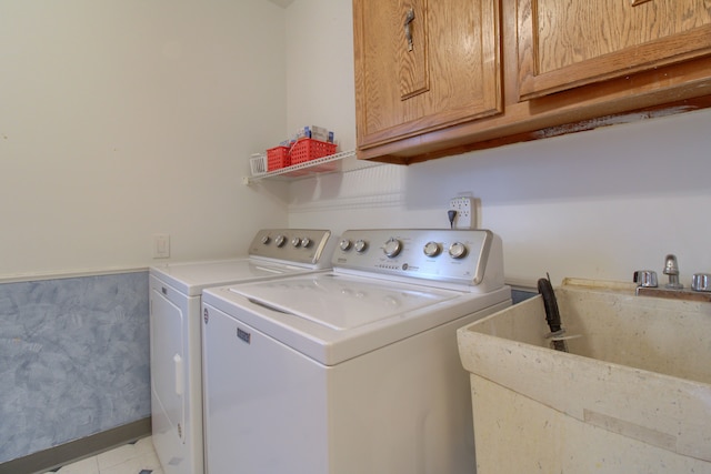 laundry area with washer and dryer, cabinet space, and a sink