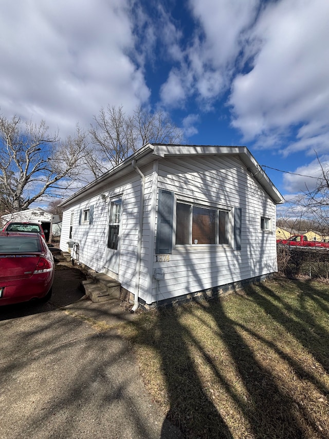 view of side of home featuring a lawn