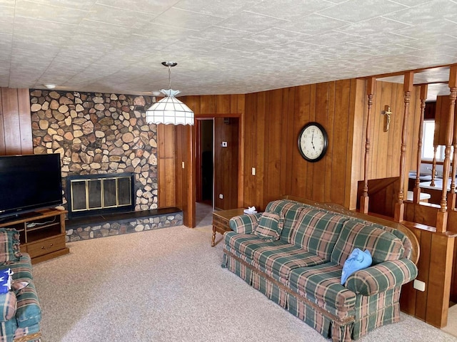 living room featuring wooden walls, carpet flooring, and a fireplace