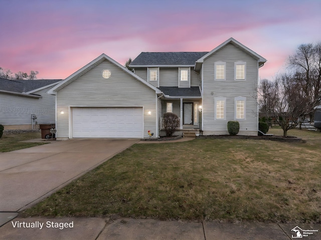 traditional-style house featuring driveway, a shingled roof, an attached garage, and a lawn