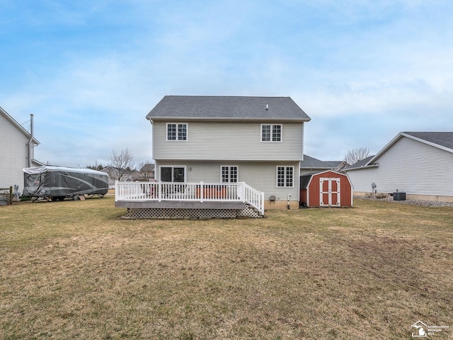 rear view of house featuring an outbuilding, central AC unit, a storage unit, a deck, and a lawn