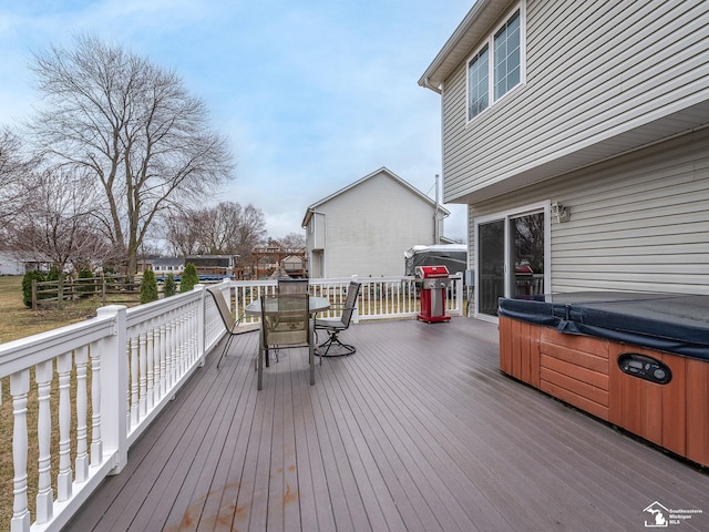 wooden terrace with area for grilling, outdoor dining area, and a hot tub
