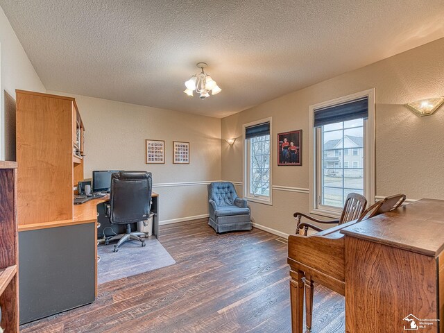 office area featuring a textured wall, a notable chandelier, a textured ceiling, and dark wood finished floors