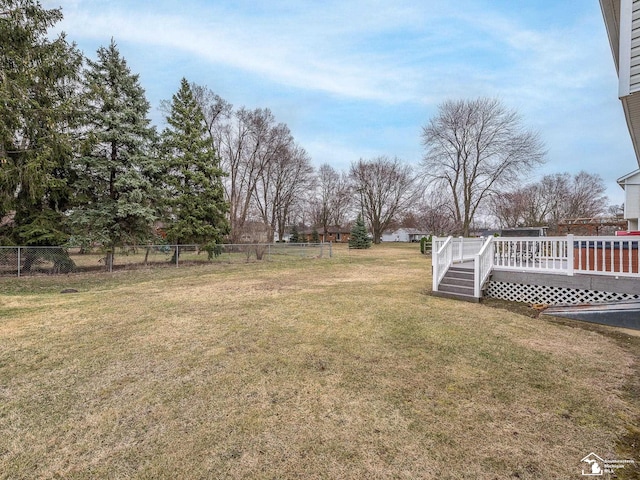 view of yard with fence and a wooden deck
