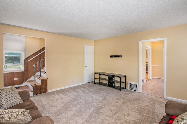 12225 Miller Rd, Grand Blanc, MI 48449 - living room featuring carpet, baseboards, stairs, and visible vents