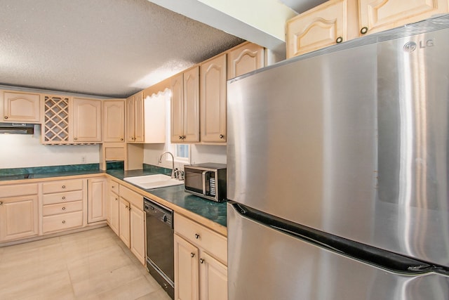 12225 Miller Rd, Grand Blanc, MI 48449 - kitchen with under cabinet range hood, a textured ceiling, a sink, dark countertops, and appliances with stainless steel finishes