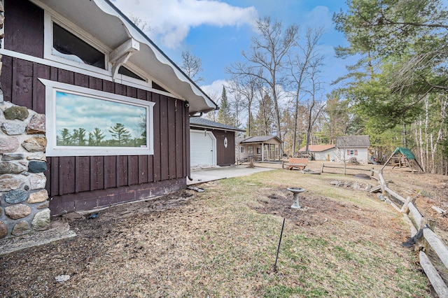 view of property exterior featuring board and batten siding and an outbuilding