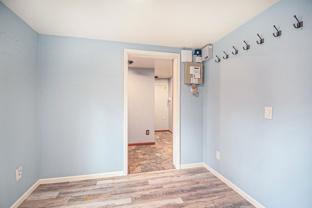 empty room with baseboards and wood finished floors