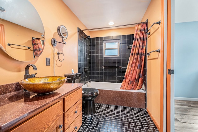full bath featuring toilet, shower / tub combo with curtain, and vanity