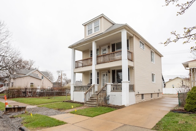 880 White Ave, Lincoln Park, MI 48146 - view of front of home with covered porch, a front yard, fence, and a balcony
