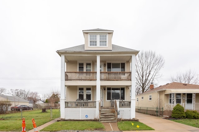 880 White Ave, Lincoln Park, MI 48146 - view of front facade with a porch, fence, a front lawn, and a balcony