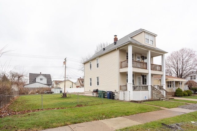 880 White Ave, Lincoln Park, MI 48146 - view of home's exterior featuring covered porch, a lawn, a chimney, a balcony, and fence private yard