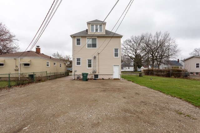 880 White Ave, Lincoln Park, MI 48146 - rear view of property featuring fence and a lawn