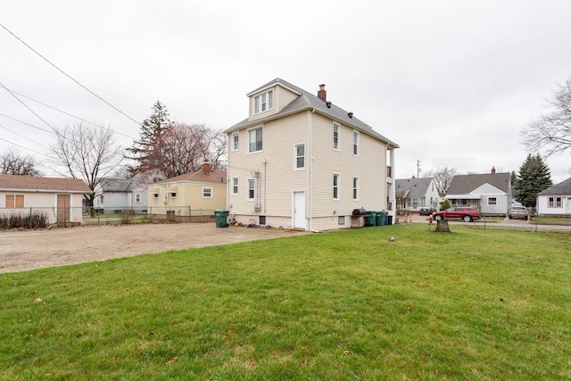 880 White Ave, Lincoln Park, MI 48146 - rear view of property featuring fence, a chimney, and a lawn